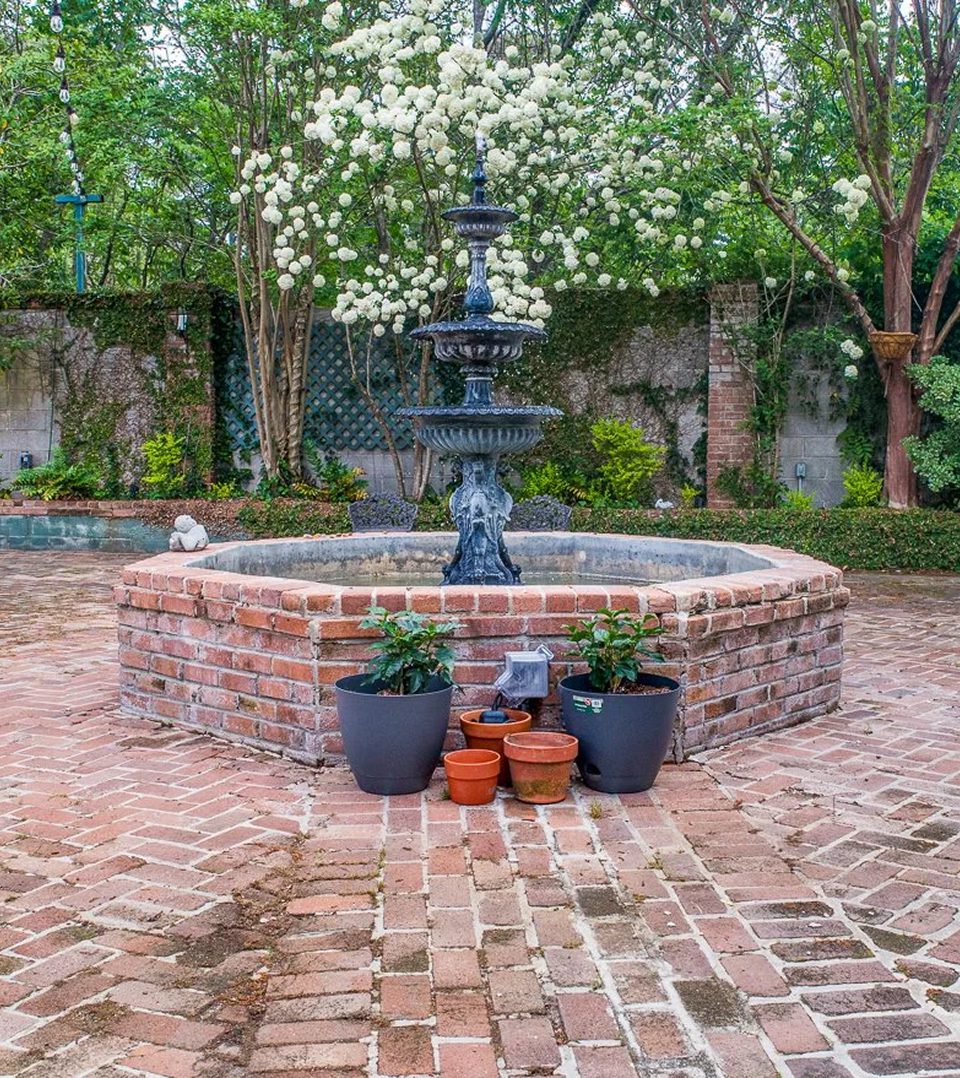 Brick fountain with potted plants