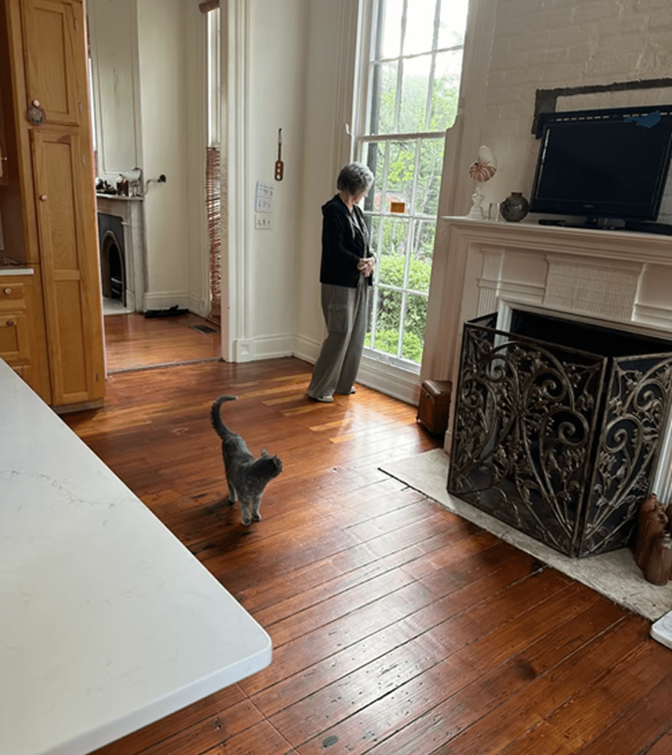 Woman and cat near a window
