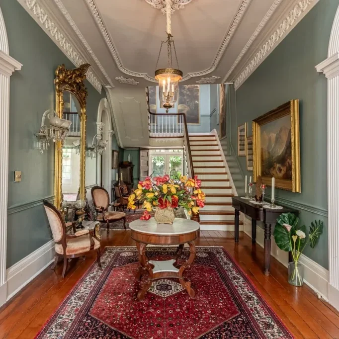 Elegant foyer with classic furniture and a grand staircase.