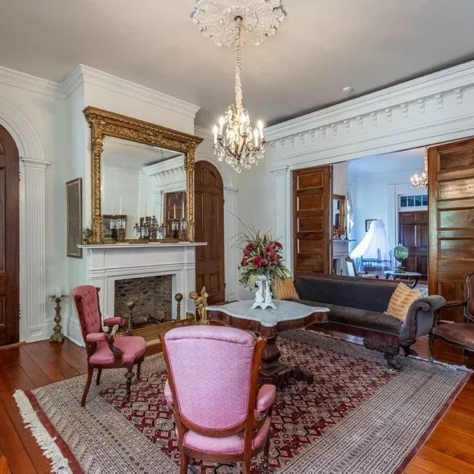 Elegant vintage living room with ornate furniture and chandelier.